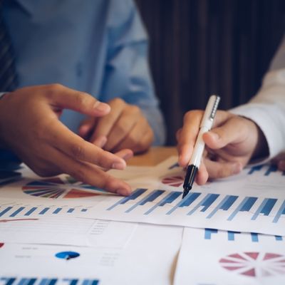 people with graphs on paper performing a commercial property valuation